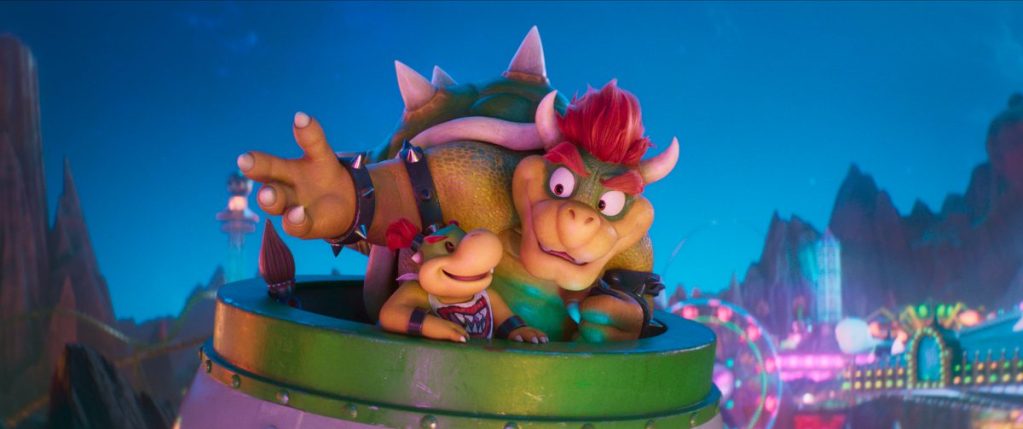 Mario character Bowser with his son sitting in a large green vehicle, set against a colorful, animated backdrop featuring vibrant lights and a whimsical environment.